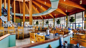 A spacious restaurant with high wooden ceilings and large windows. - ⛵Gulf Front with Fab Amenities-Edgewater 3-1104⛵ (Panama City Beach)
