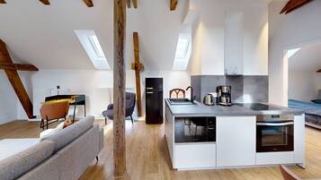 Eine moderne Lofts-Wohnung mit Küche, Essbereich und Wohnraum.