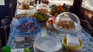 A table set for a meal with various food items, plates, and utensils.