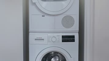 A stacked Bosch washing machine in a laundry room.