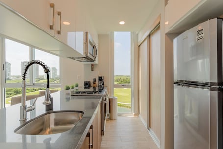 Suite with Balcony, Golf Course View | Private kitchen | Full-size fridge, microwave, oven, stovetop