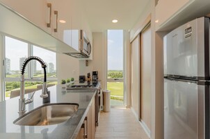 Suite with Balcony, Golf Course View | Private kitchen | Full-size fridge, microwave, oven, stovetop