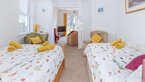 A hotel room with two beds, a TV, and a view of the outdoors. - 1 bedroom accommodation in Ventnor (Ventnor)