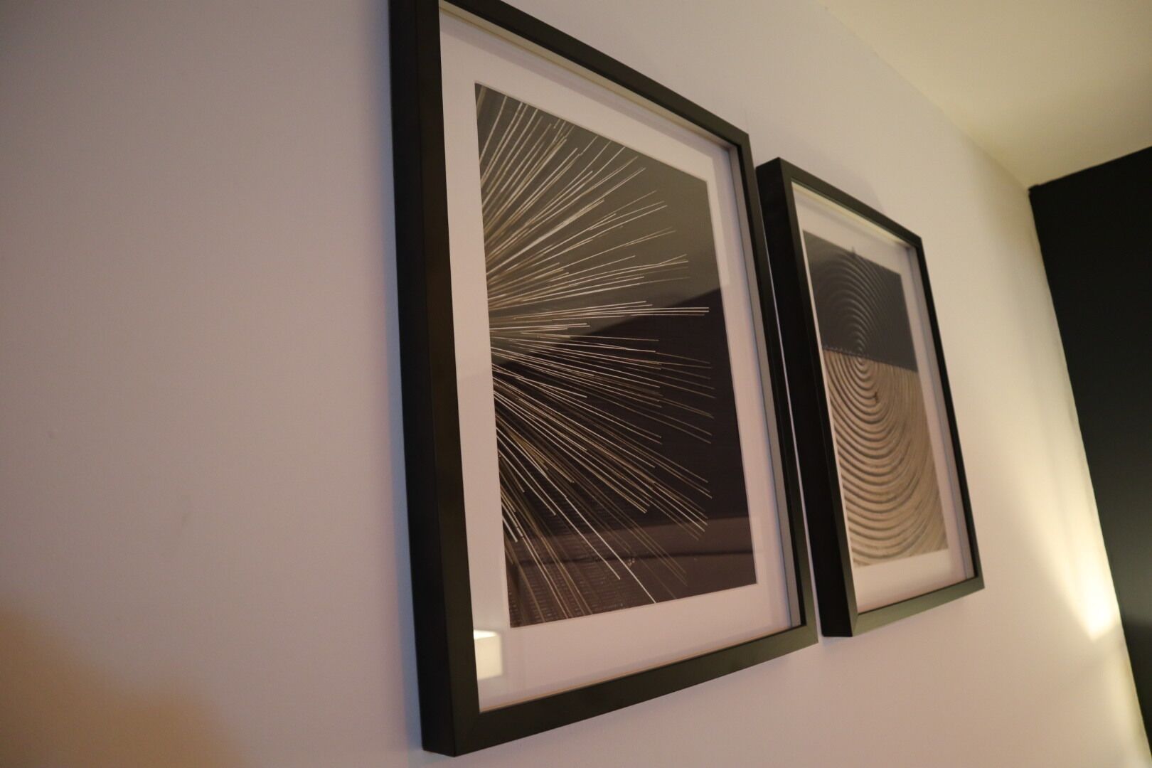 Two framed abstract art pieces on a wall.