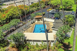 Enjoy a refreshing dip in the rooftop pool surrounded by lush greenery.