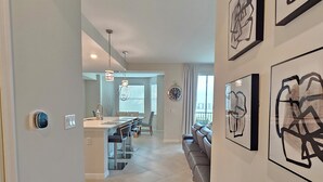 A modern kitchen with a central island, pendant lighting, and a dining area with a sofa and chairs. -  18-hole Golf Course Condo. Two bedrooms-Two bath with amazing views  (Ave Maria)