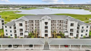 A multi-story hotel with a central courtyard and a parking area. -  18-hole Golf Course Condo. Two bedrooms-Two bath with amazing views  (Ave Maria)