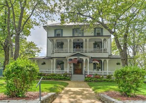 A two-story house with a porch, a front door, and a mailbox. - Find genuine southern hospitality in Hendersonville at the 1898 Waverly Inn. (Hendersonville)