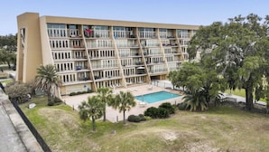 A multi-story hotel with a pool and outdoor seating area. - Imagine Waking Up to This View! Relax at the 2 Bedroom Beach Condo in Biloxi, MS (Biloxi)
