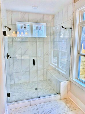 Shower, hair dryer, towels, shampoo