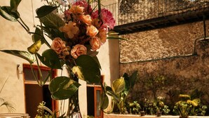 A table set with pastries, a coffee cup, and a vase of flowers. - Hotel Boutique Casa Jade (Campeche)