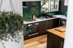 Enjoy cooking in this well-equipped kitchen with a range hood, double oven, and dishwasher.