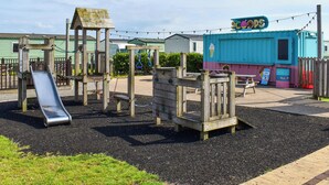 Un parque infantil con un tobogán y estructuras para escalar.