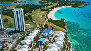 A coastal resort with high-rise buildings, a beach, and a golf course. - Beachfront Breeze Condo (Philipsburg)