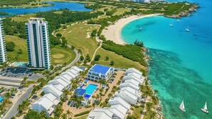 A resort with a pool, beach, and ocean views. - Beachfront Breeze Condo (Philipsburg)