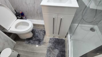 Shower, hair dryer, towels, shampoo