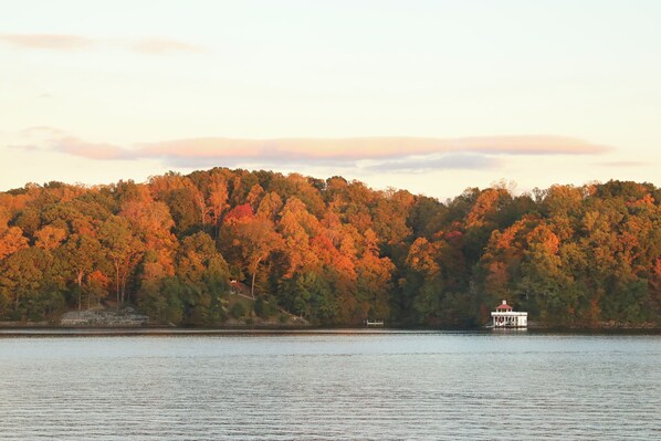 A lake with a dock and a small house-like structure on the shore. - Corner SML Waterfront Penthouse Condo-King Beds (Moneta)