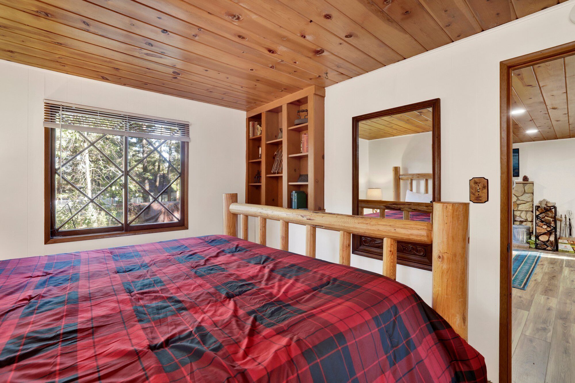Peaceful cabin bedroom with plush bedding, and beautiful views—ideal for restful nights, cozy mornings, and a relaxing mountain escape.