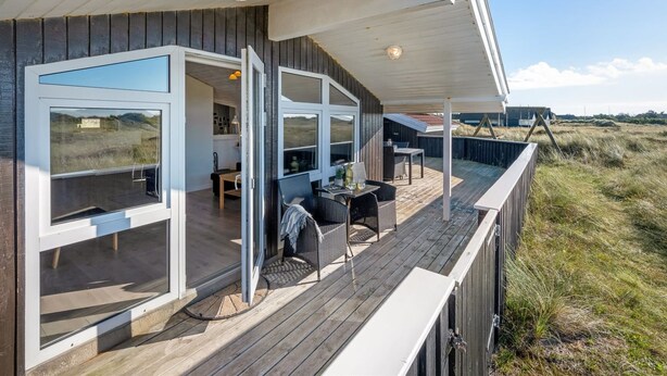 A modern coastal house with a deck, large windows, and a view of the beach. - "Jaana" - 10m from the sea by Interhome (Blåvand)