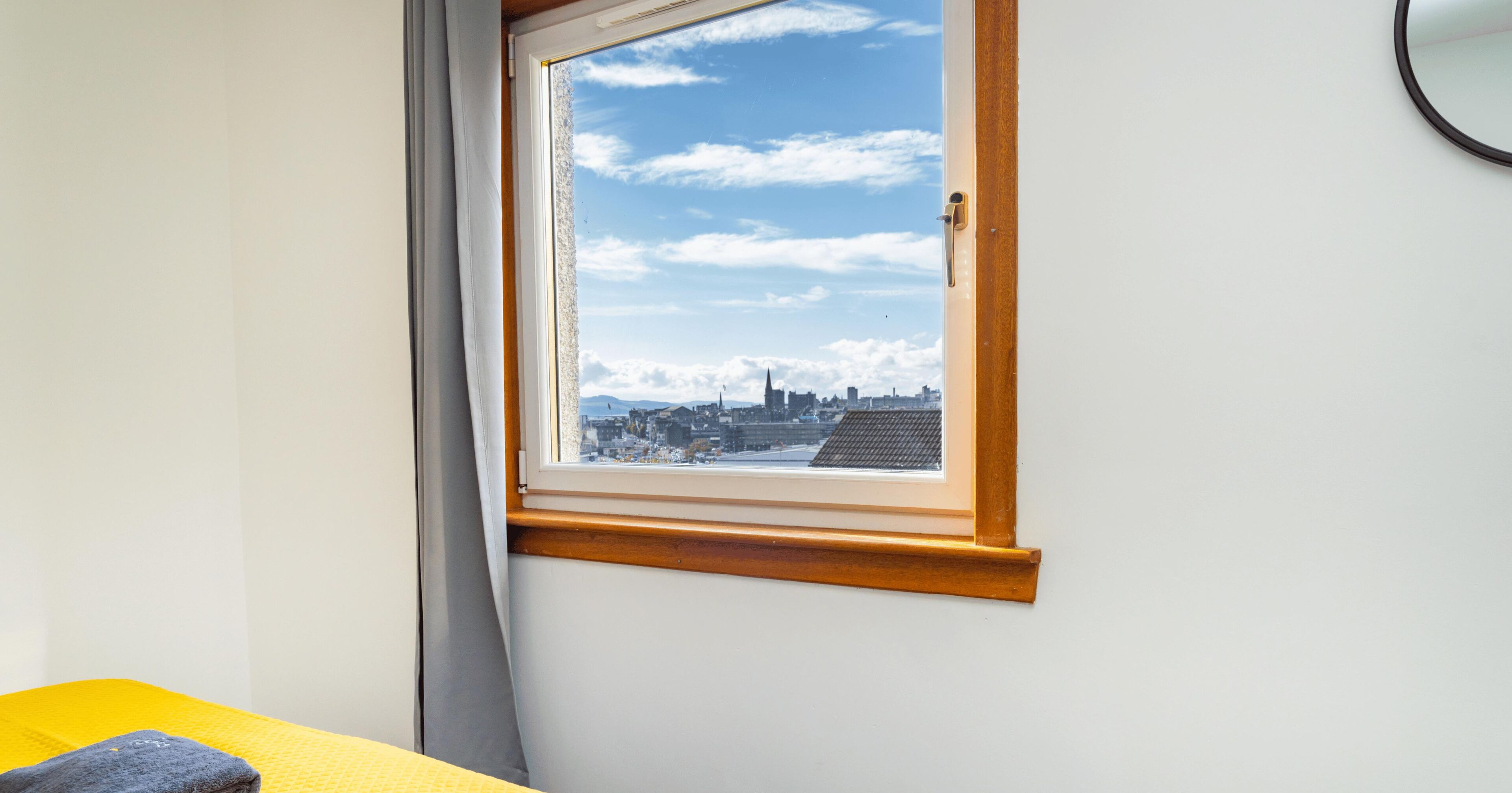 A room with a window overlooking a cityscape.