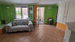 A living room with a sofa, a small table, and a cabinet. - Oasis on the Montgo, cozy apartment with large covered terrace (Dénia)