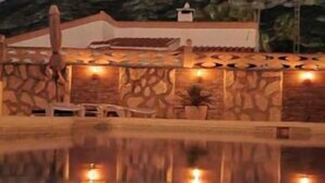A pool area with a stone wall and a mountain in the background. - Oasis on the Montgo, cozy apartment with large covered terrace (Dénia)