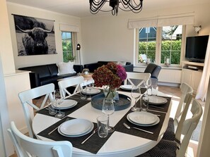 Enjoy meals with family and friends at this stylish dining area, featuring a round table for four, comfortable seating, and a beautiful view.