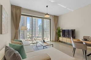 Relax in a stylish living room with a sofa set, coffee table, dining area, and flat-screen TV.