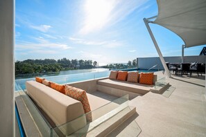 A rooftop terrace with a pool, outdoor seating, and a view of the surrounding landscape. - Angsana Oceanview Residences by Banyan Living (Choeng Thale)