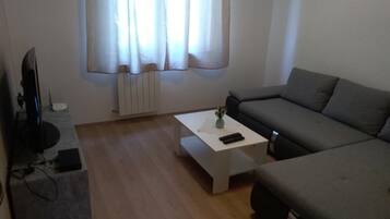 Apartment (Two Bedroom Apartment with Balcony) | Living room | 32-inch flat-screen TV with cable channels