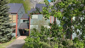 A building with a sloped roof, a pathway leading to the entrance, and a mountain backdrop. - Telluride Lodge, Your mountain gateaway with amazing service and very affordable (Telluride)