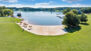A lakeside resort with a sandy beach, a pavilion, and a boat dock. - Loft Condo with Stunning Lake Views (Moneta)