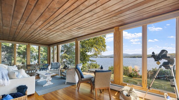 A spacious room with large windows, a wooden ceiling, and a telescope on a tripod. - Point Comfort On Lake Winnisquam (Sanbornton)