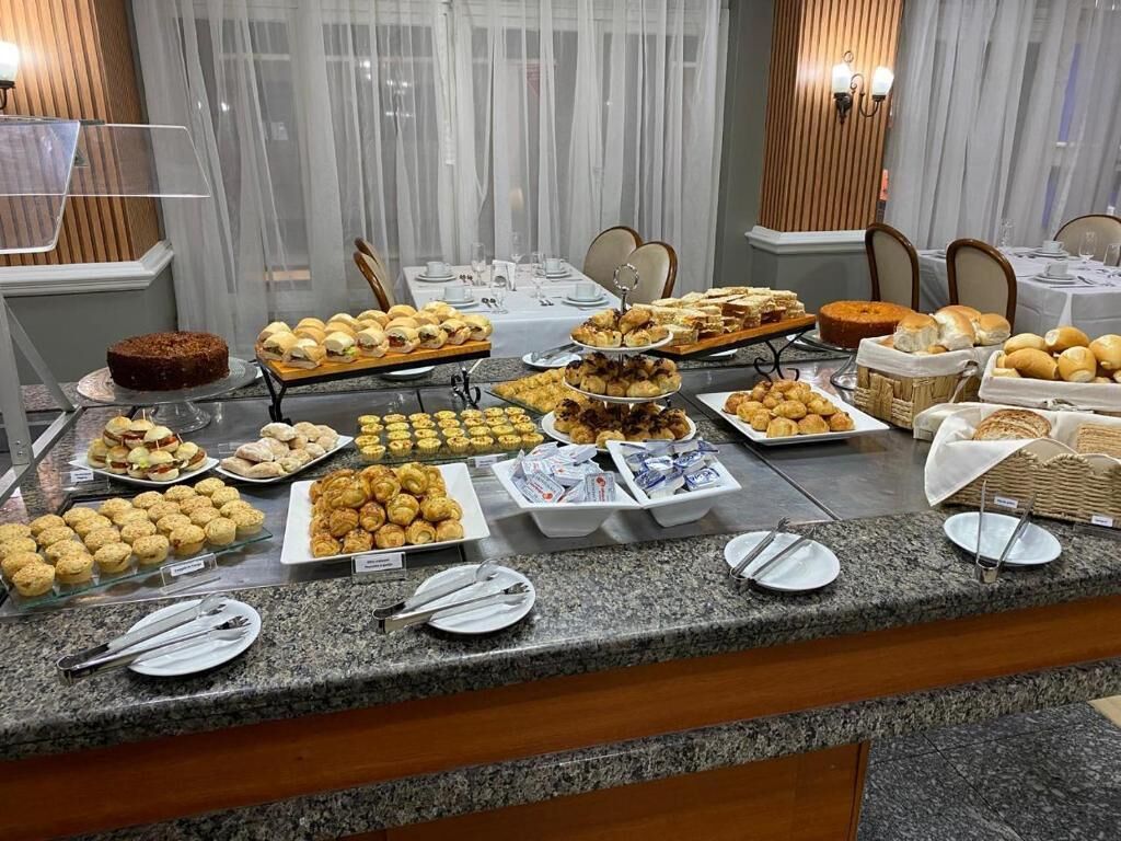 A buffet with various pastries and desserts.