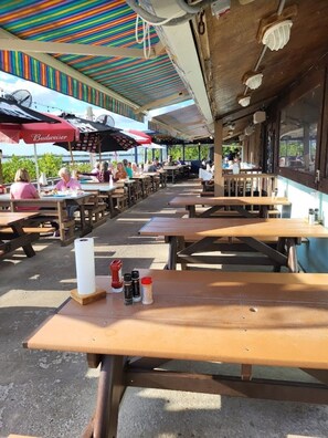 Outdoor dining - Beach side family friendly Happy Home, steps from no drive beach. (New Smyrna Beach)