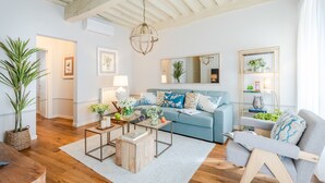 A living room with a blue sofa, a wooden coffee table, and a bookshelf. - Contemporary 2 Bedrooms Apartment in Montecarlo (Montecarlo)