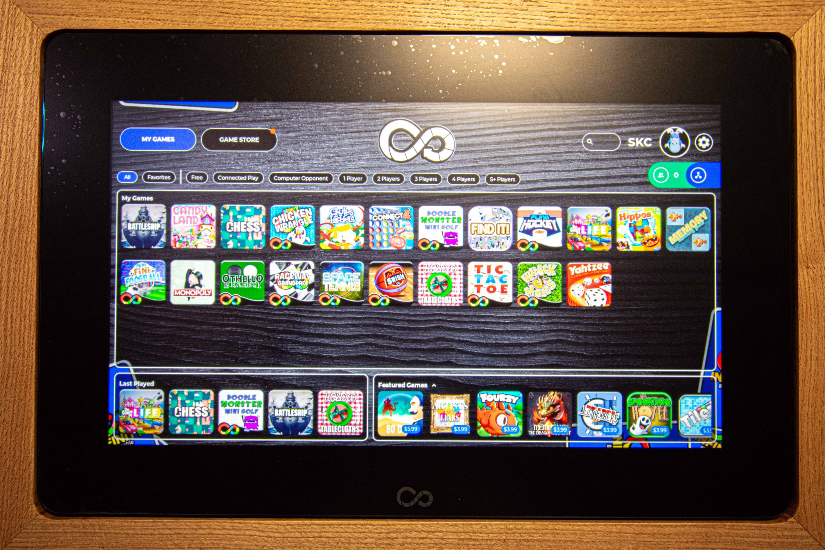 A tablet displaying a game store interface with various game icons.