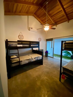 Simple, functional accommodation with a bunk bed setup and a window offering a view of the outdoors.