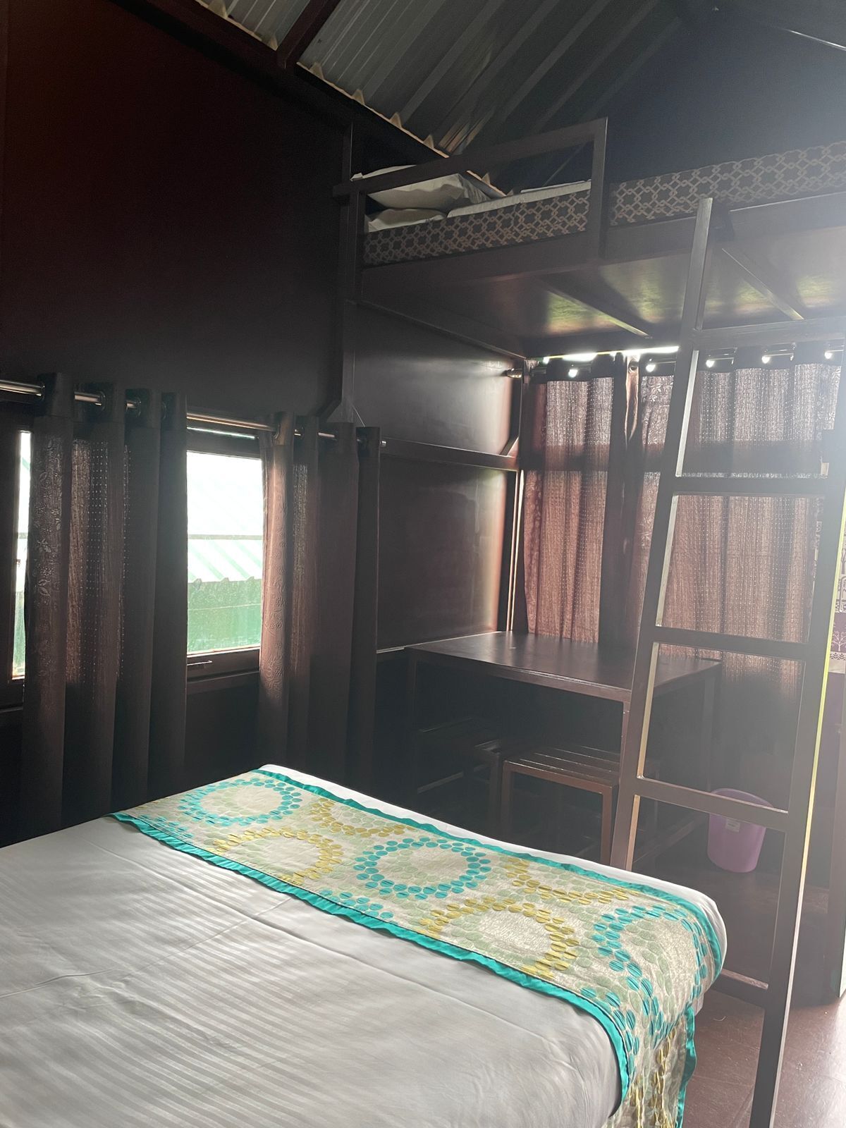 A room with a bed, a window, and a bunk bed.