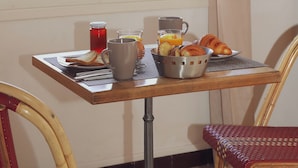 A breakfast table with croissants, juice, and a bowl of fruit. - A Rossa Location (Conca)