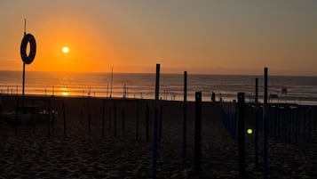 On the beach, white sand, beach cabanas, sun-loungers