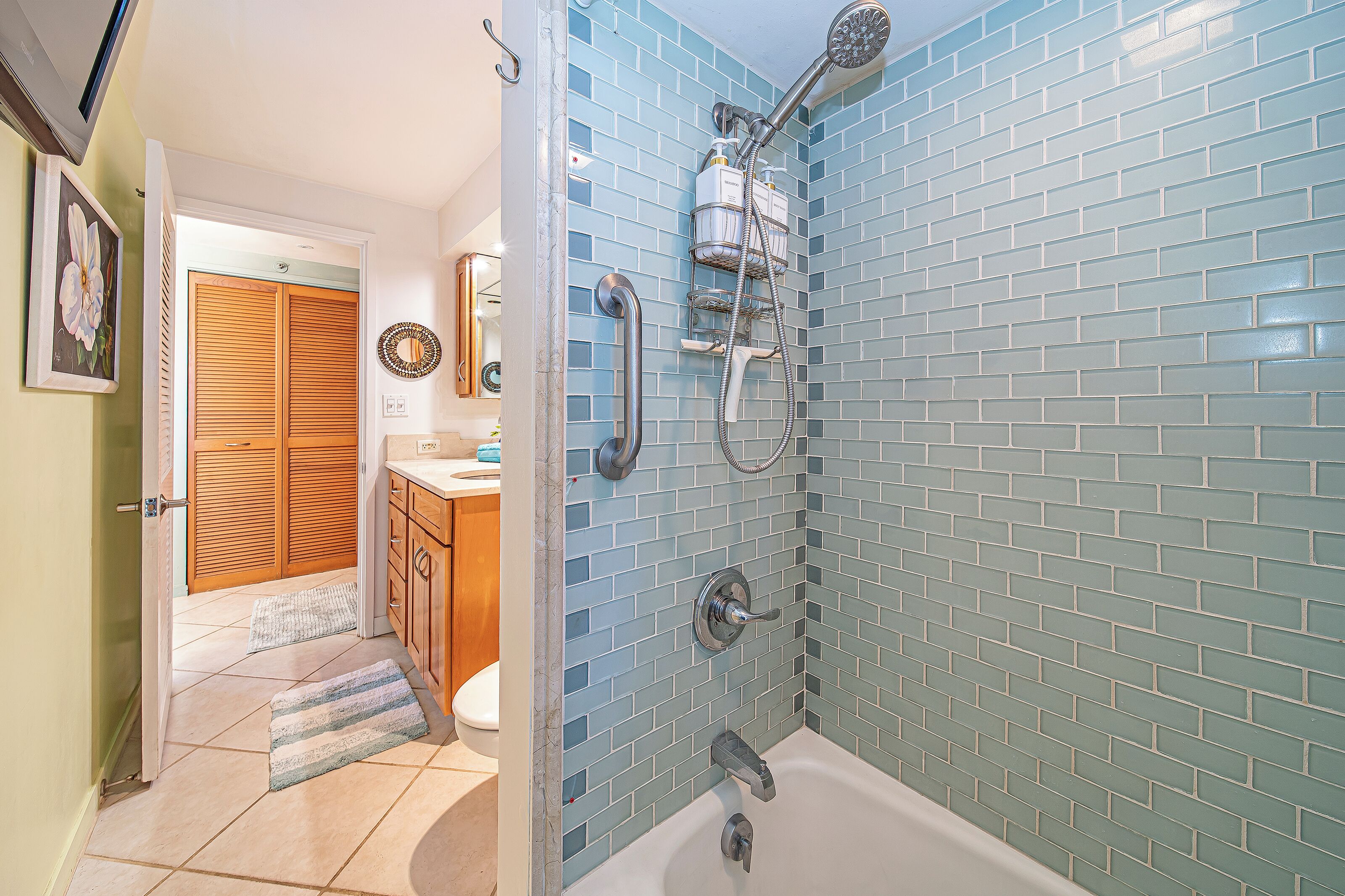 A bathroom with a shower, a toilet, and a sink.