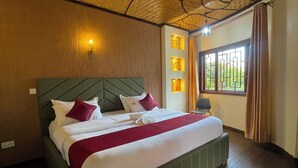 A neatly made bed with a green headboard, a red and white bedspread, and a window with curtains. - De Rain Eco Beach Resort (Entebbe)