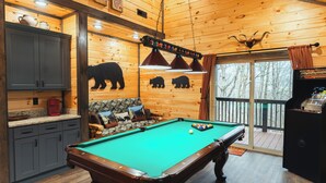 A pool table in a wooden cabin with a sofa and a coffee maker. - New Build! Charming Wears Valley Cabin! Close to National Park and Attractions! (Sevierville)