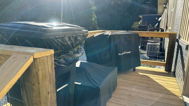 A covered outdoor deck with a hot tub and a covered grill area. - CLEARFORK CREEK LODGING & RV CAMPGROUND#4 (LaFollette)
