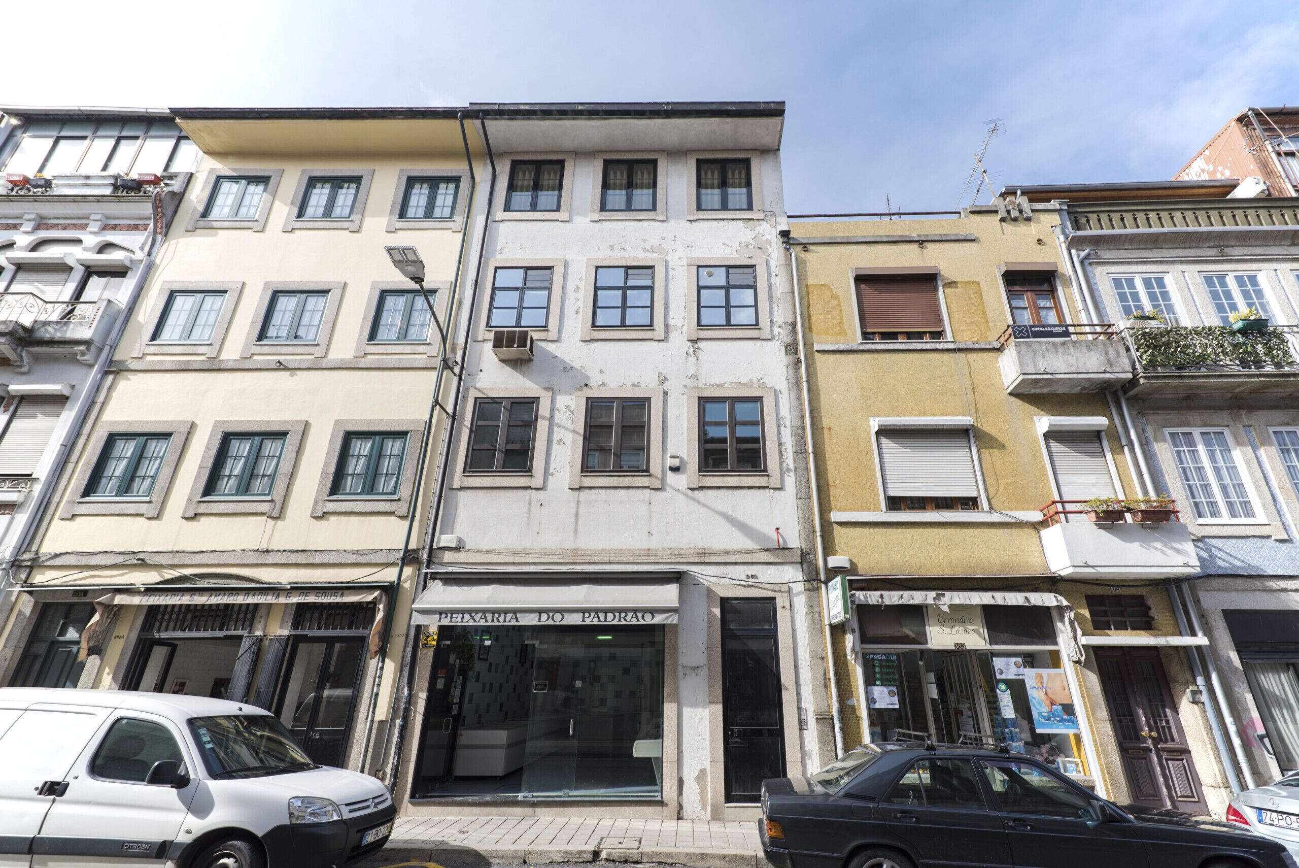 A multi-story building with a ground-floor shop and a visible entrance.