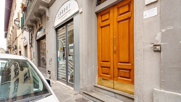 A building with a large wooden door, a sign reading 'LOGOUT RECORDS,' and a number '37' on the wall.
