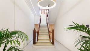 A staircase with wooden railings and a light fixture above it.