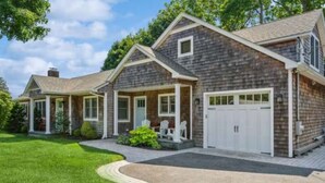 A two-story house with a garage, a covered porch, and a well-maintained lawn. - Country BEACH home! (Southold)