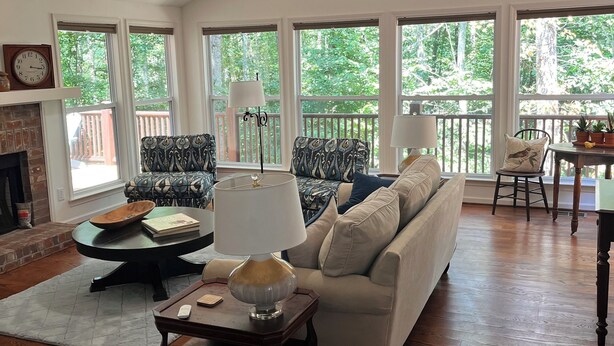 A spacious living room with a high ceiling, large windows, a fireplace, and a ceiling fan. - Pollys Place for bird lovers - Private, Close to Gallatin-Sleeps 10-Pet Friendly (Portland)